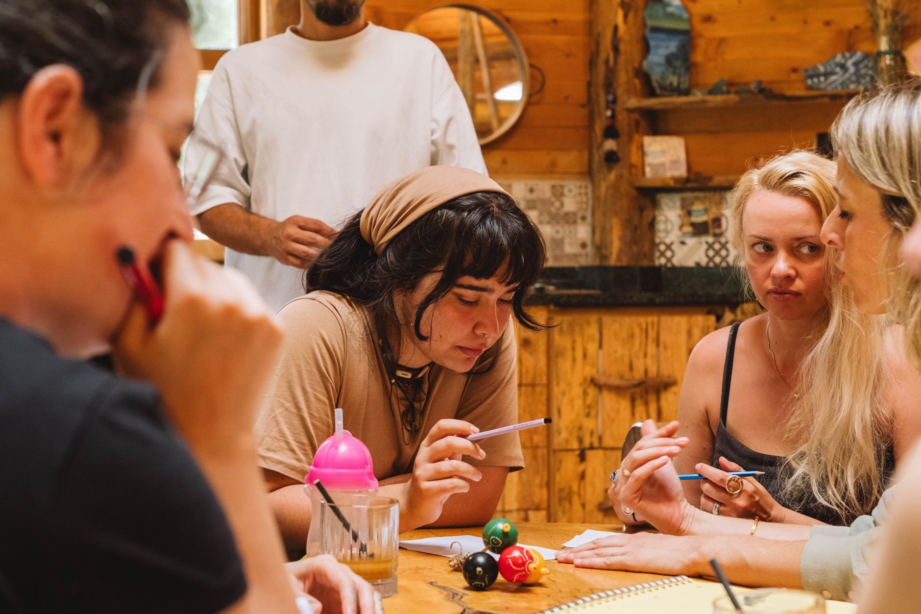 A diverse group of adults in discussion around a table, engaging in a planning session.